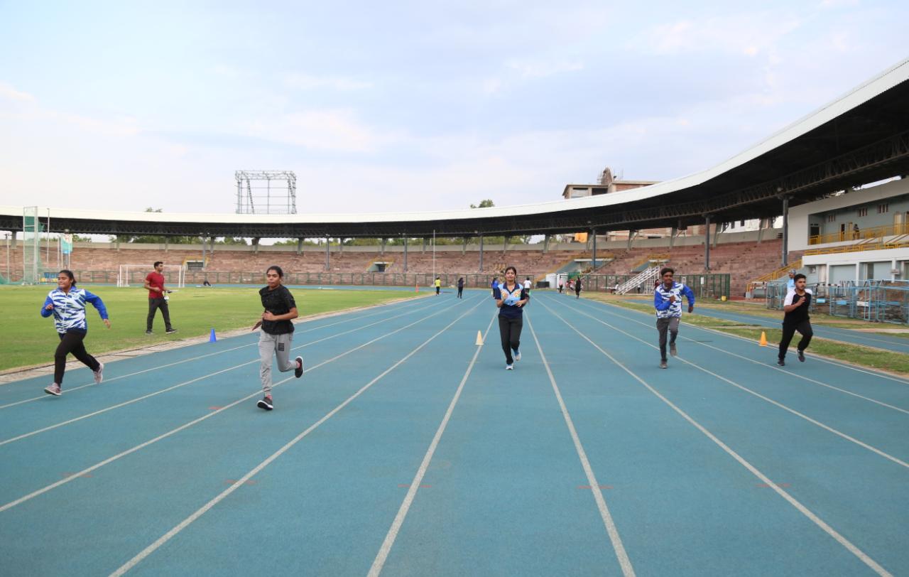 Players practicing and warming up on the track