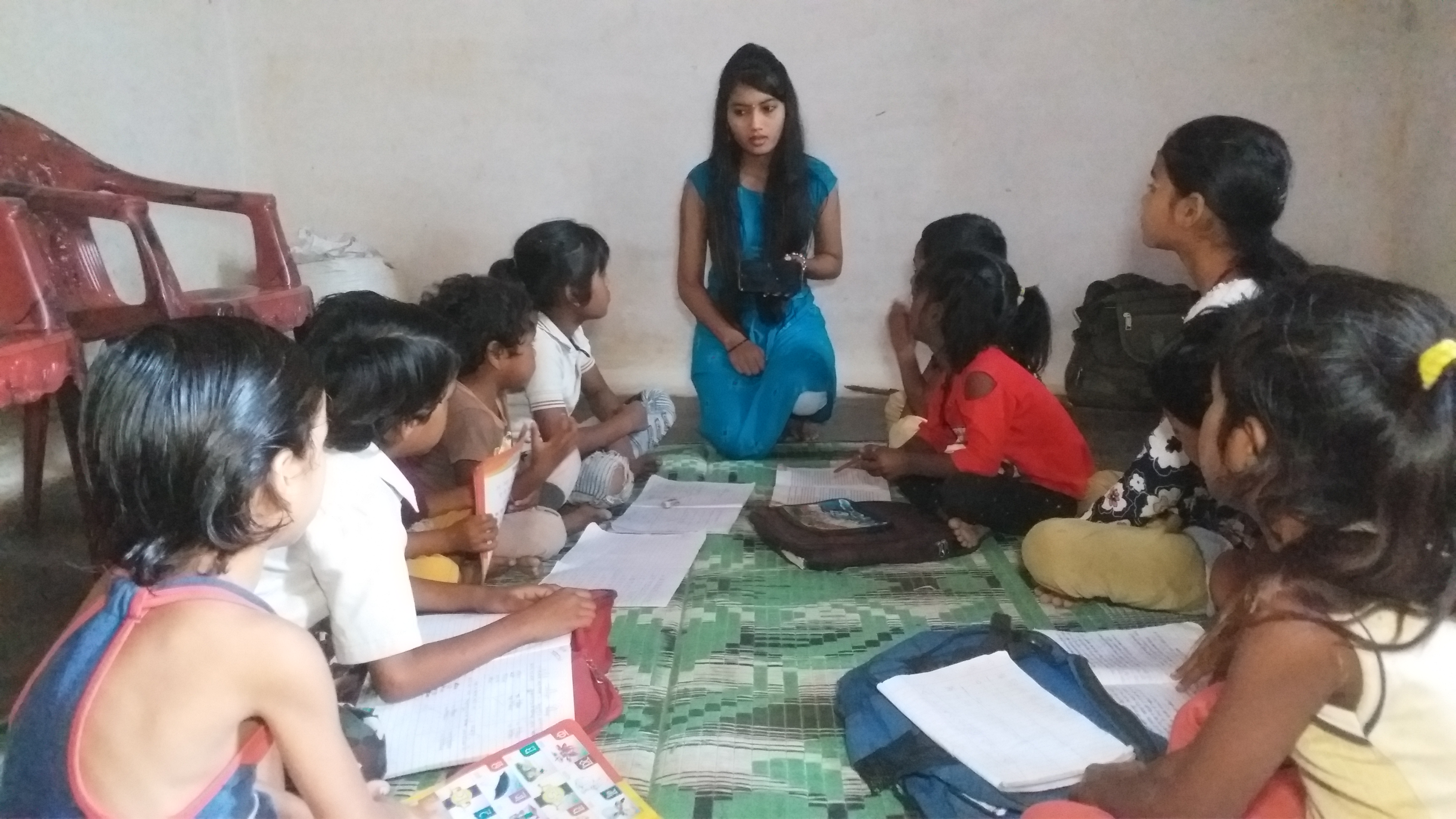 Students teaching poor children by phone