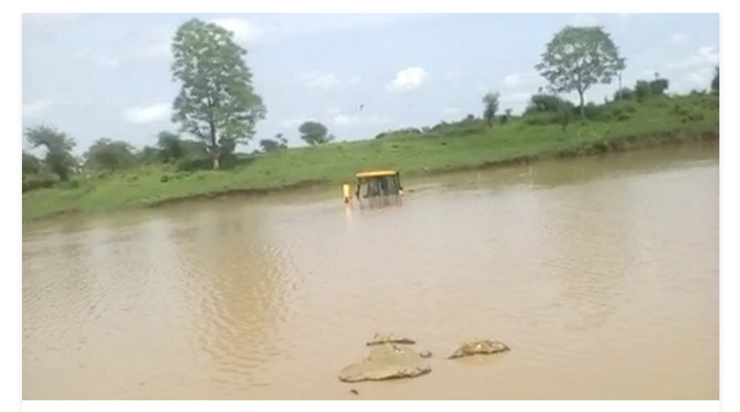 JCB immersed in rain