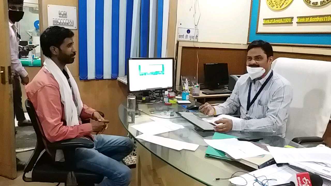 Pradeep Singh sitting near bank manager