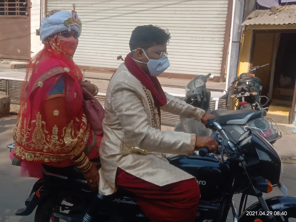 Bride and groom running on bike