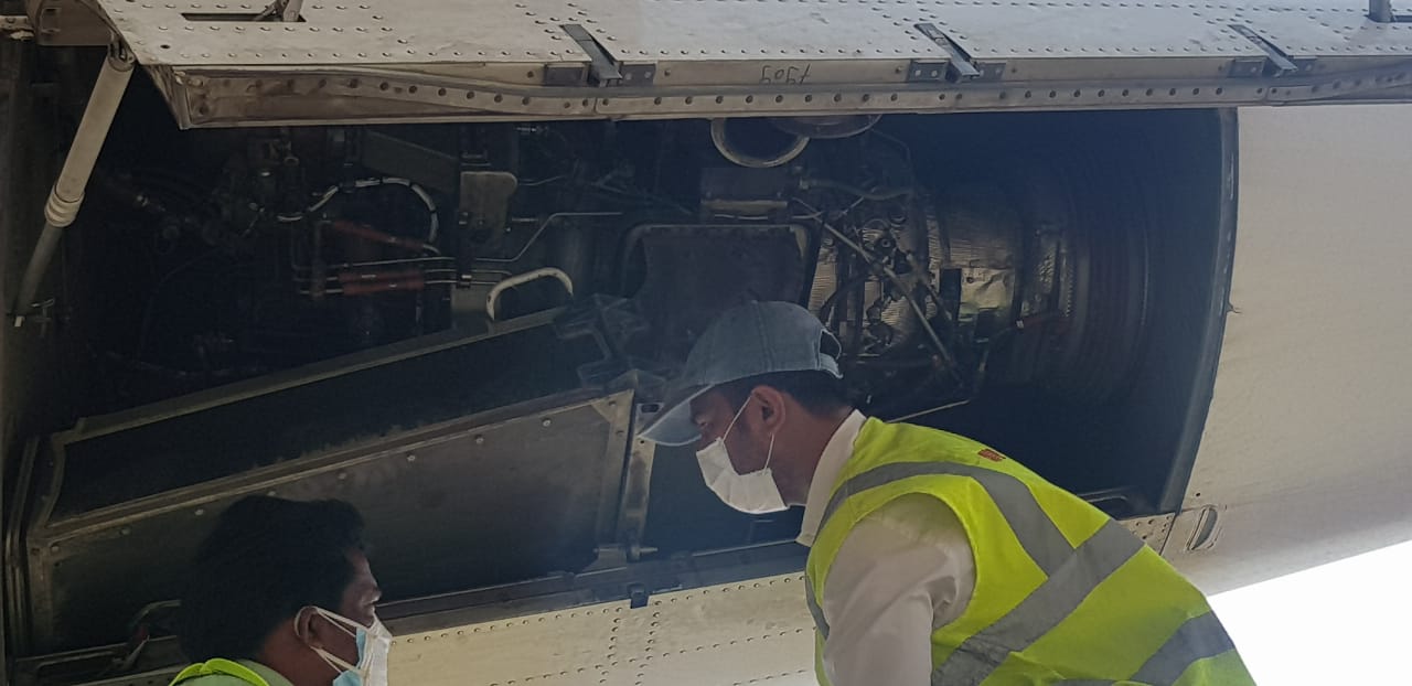 Technical team examining the plane