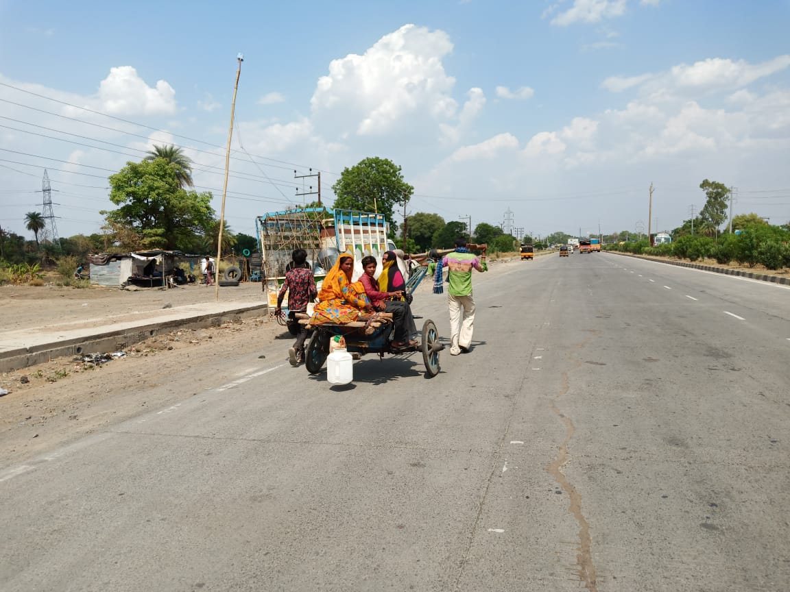 painful pictures of migration, A man pulling a bullock cart with a bull in indore