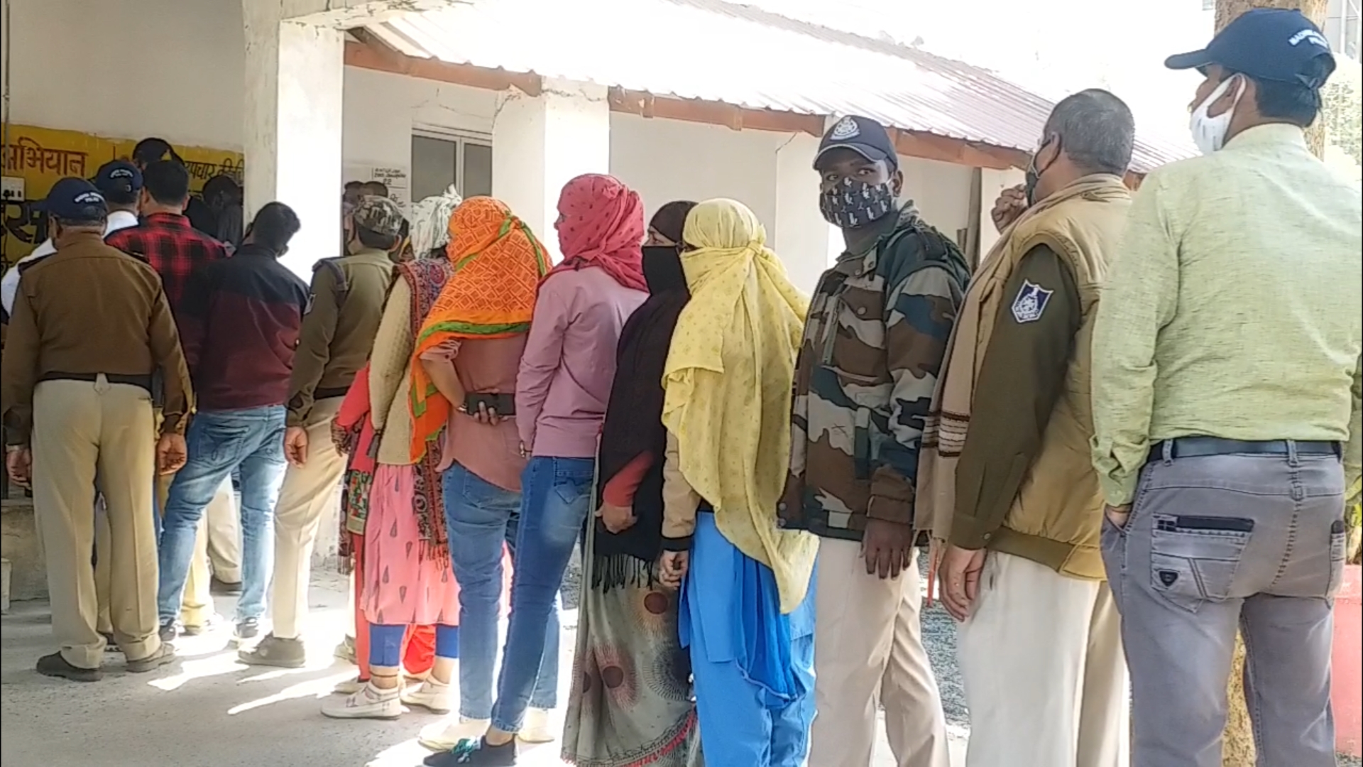 Policemen putting vaccine in line