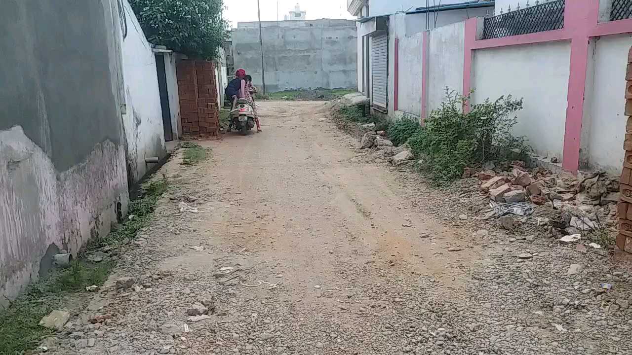 dilapidated road in illegal colony