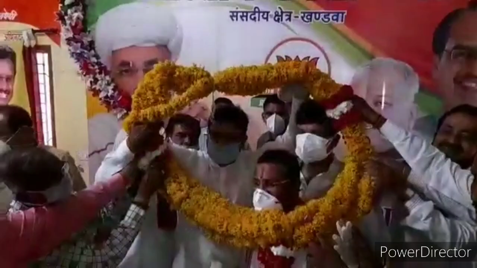 BJP workers garlanding the minister