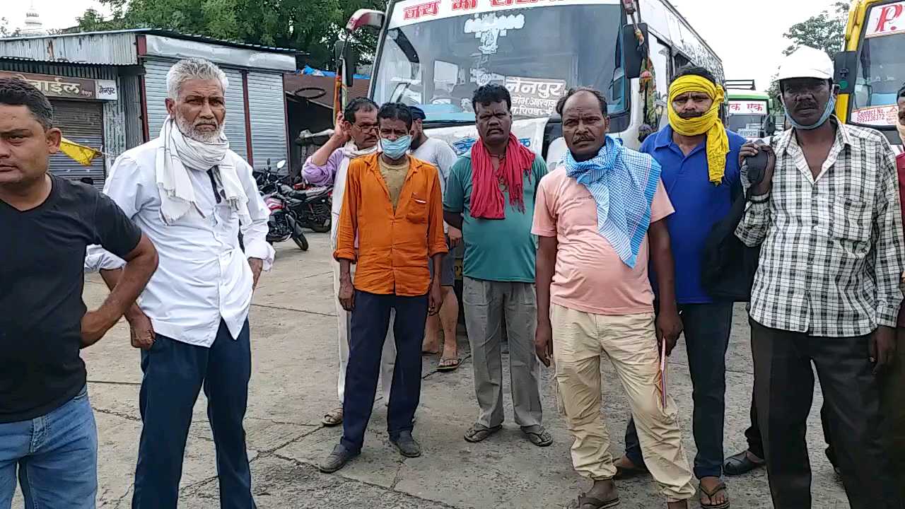 Bus driver standing at bus stop, conductor