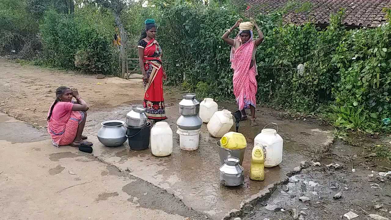 People waiting for their turn to fill water