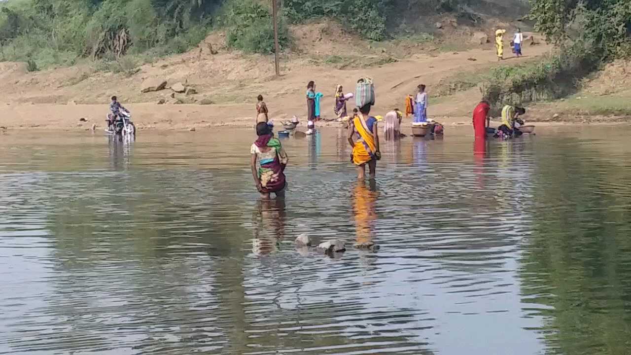 People crossing the river putting their lives at risk