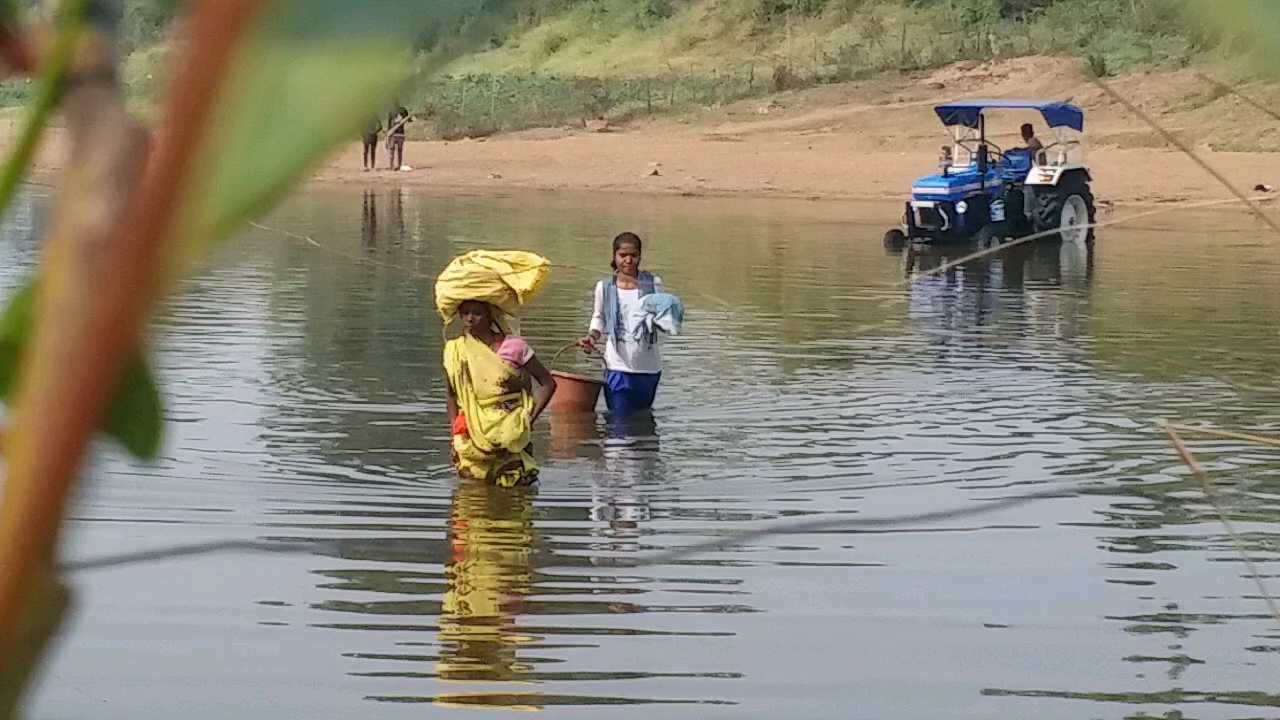 People crossing the river putting their lives at risk