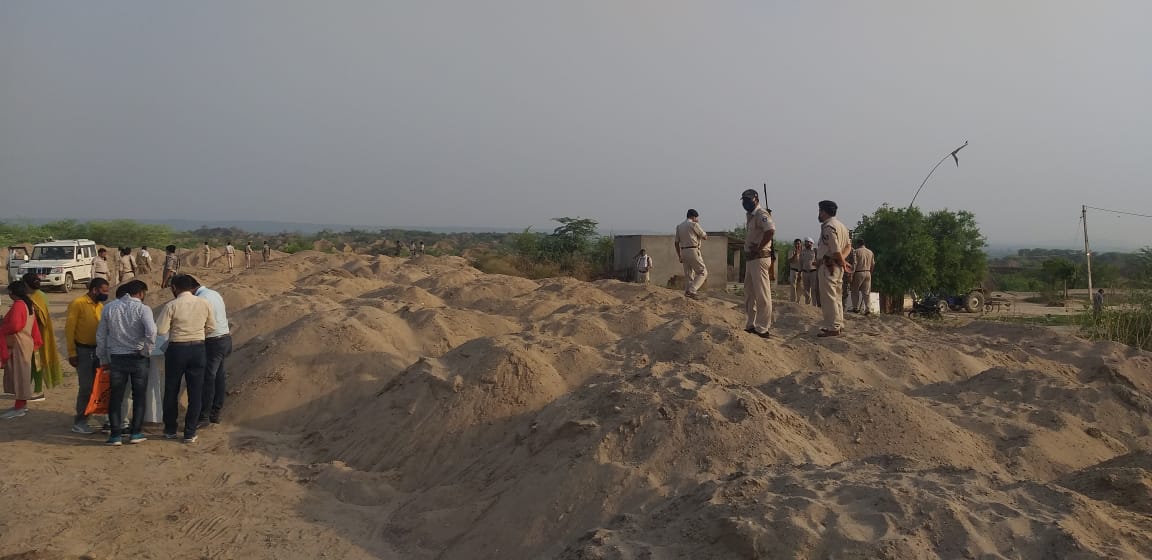 Officer inspecting illegal sand