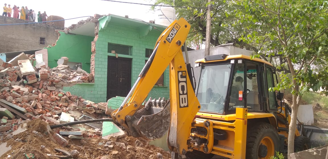 Bulldozer at the house of accused