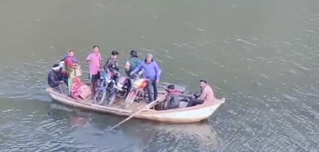 Villagers ride by boat in Seoni