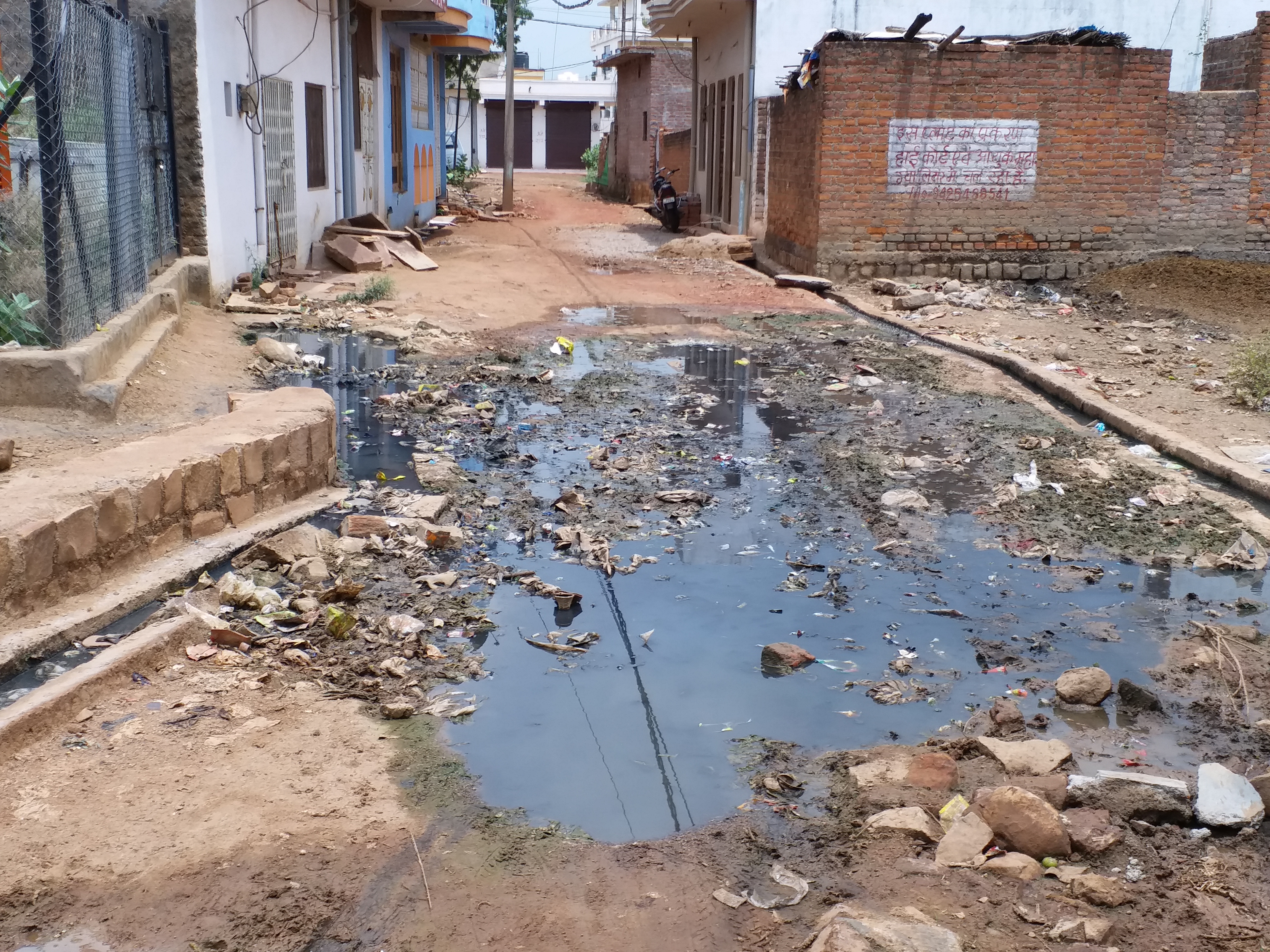 Dirt filled the road due to rain water