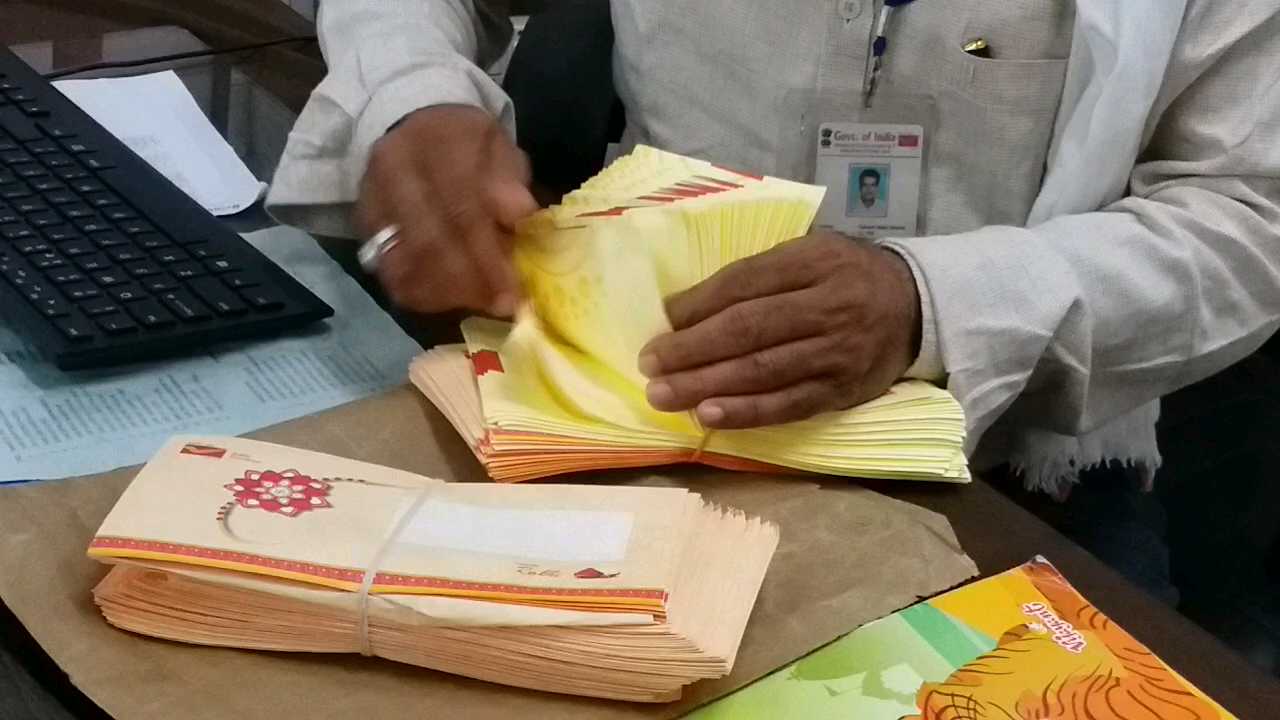 Rakhi LifafaPost man counting Rakhi envelopes