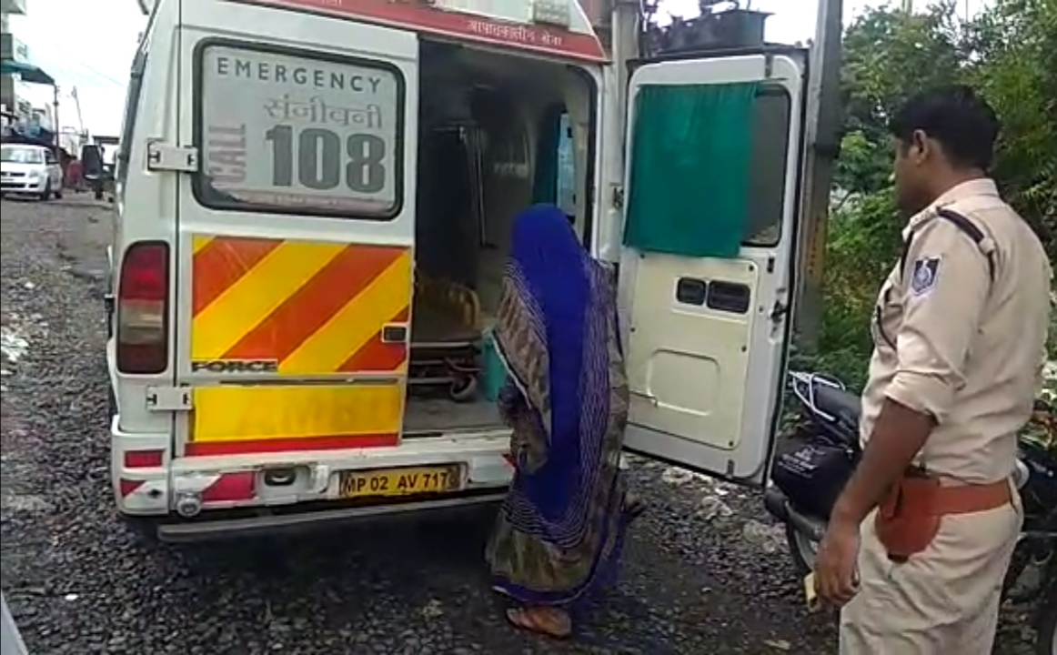 A woman sitting in an ambulance