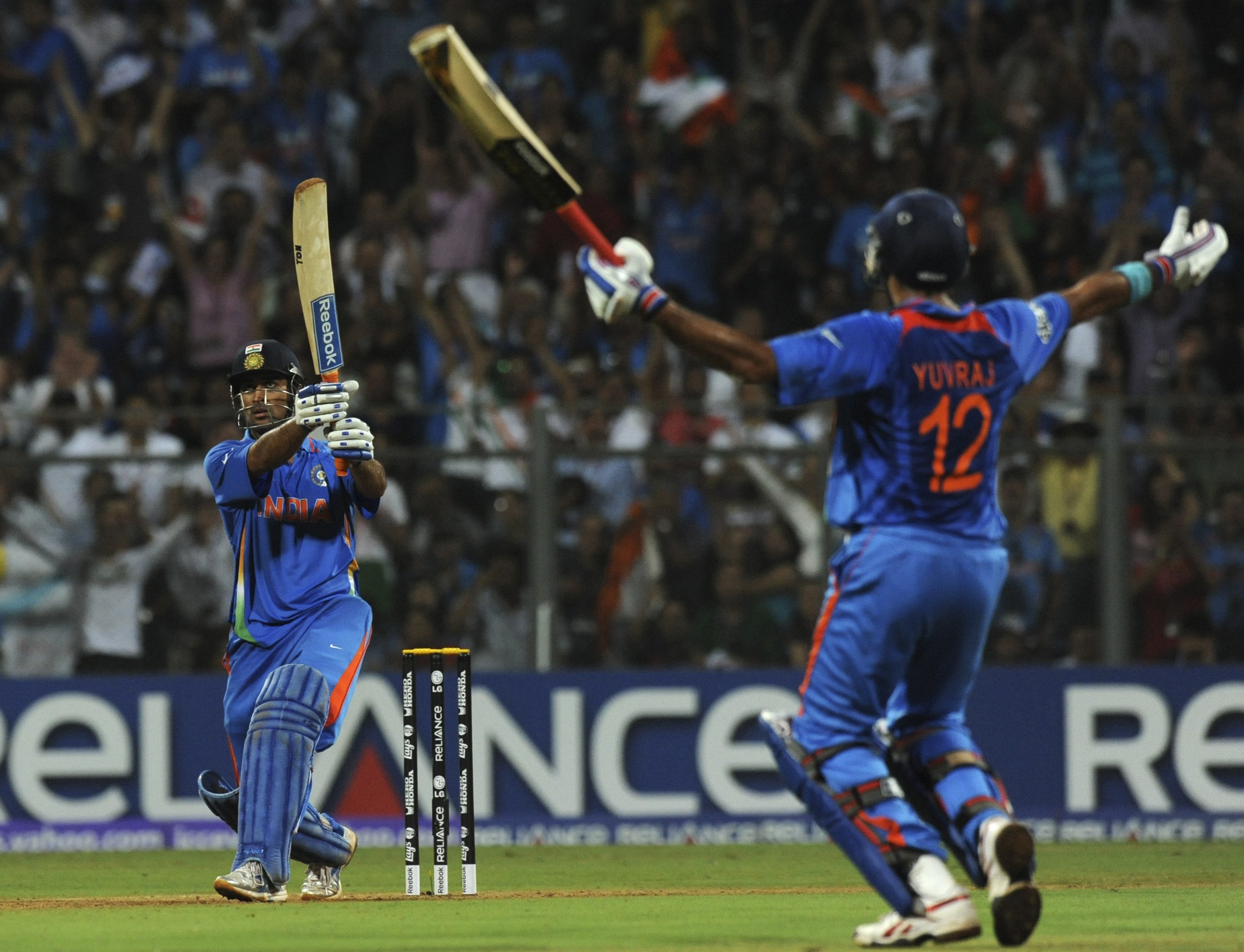 MS Dhoni winning the 2011 World Cup final smashing a six over the long on boundary.