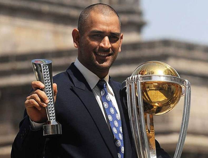 MS Dhoni with the World Cup trophy and Man of the Match trophy award.