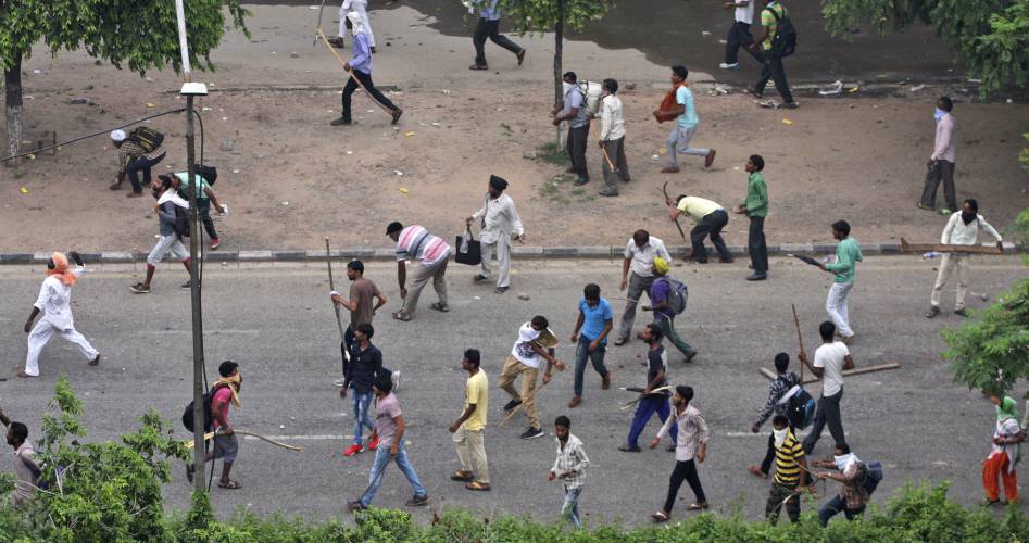 Violent rioters pelting stones at the police