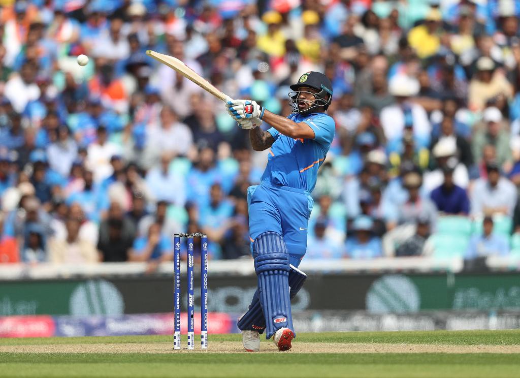 Shikhar Dhawan smashes a boundary against Australia during his 117 runs knock.