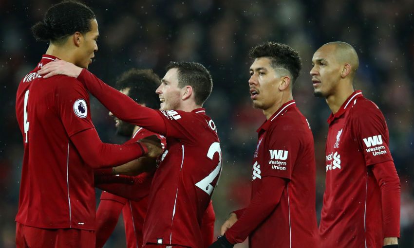 Virgil van Dijk and Andrew Robertson celebrate together during an EPL match.