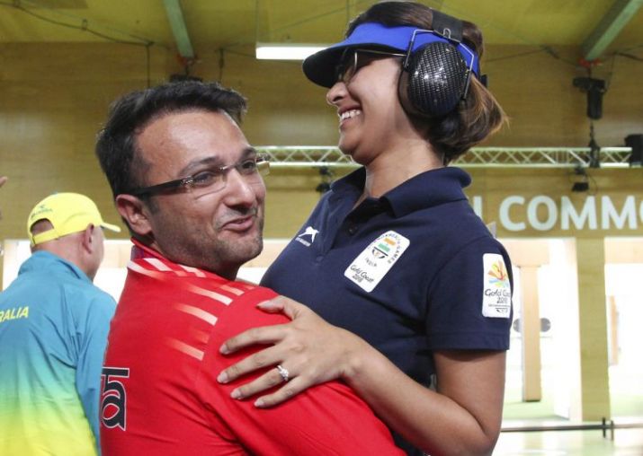 Ronak Pandit lifts gold medal winner Heena Sidhu.