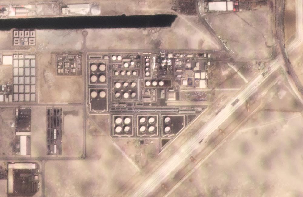 In this satellite image provided by Planet Labs PBC, white fire suppressing foam is seen after an attack on an Abu Dhabi National Oil Co. fuel depot in the Mussafah neighborhood of Abu Dhabi, United Arab Emirates, Monday, Jan. 17, 2022. A drone attack claimed by Yemen's Houthi rebels targeting a key oil facility in Abu Dhabi killed three people on Monday and sparked a fire at Abu Dhabi's international airport.