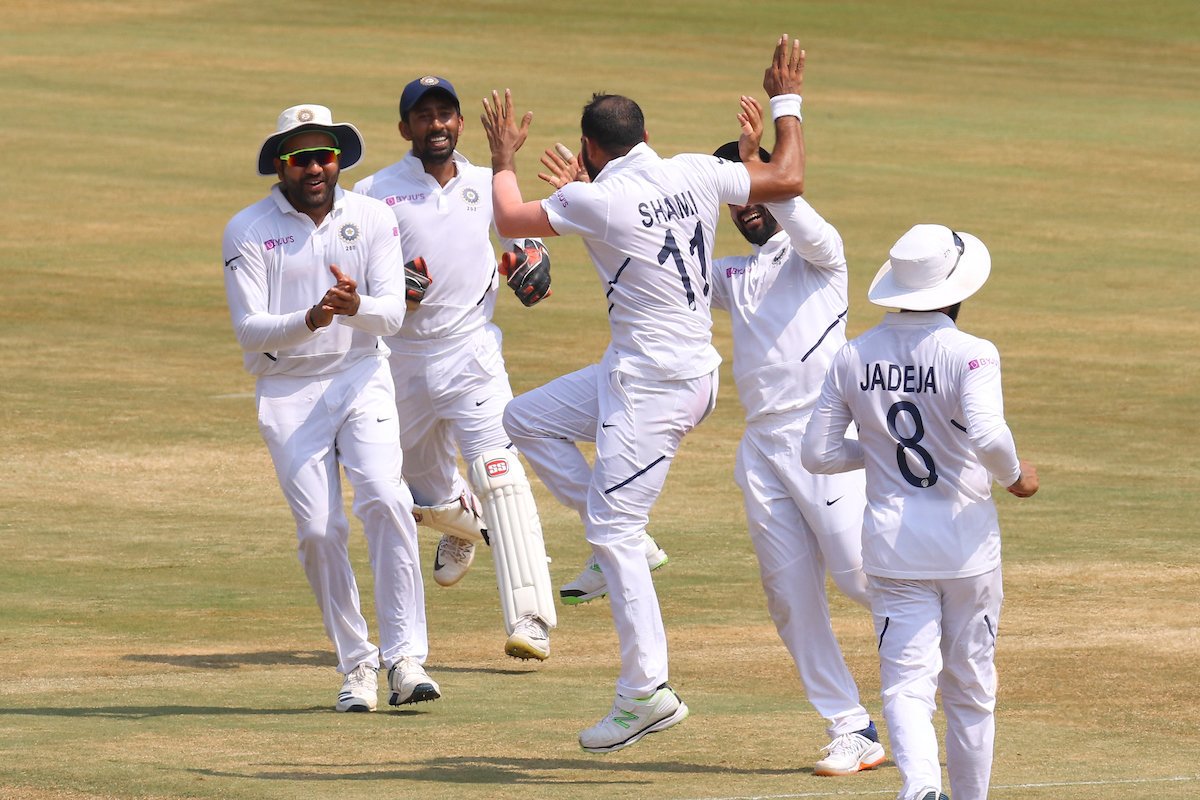 Mohammed Shami celebrates with teammates after taking a wicket.