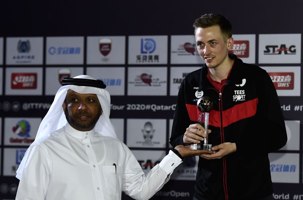 Fan Zhendong of China poses on the podium after beating Liam Pitchford of England during men's singles final match at 2020 ITTF Qatar Open in Doha, Qatar.