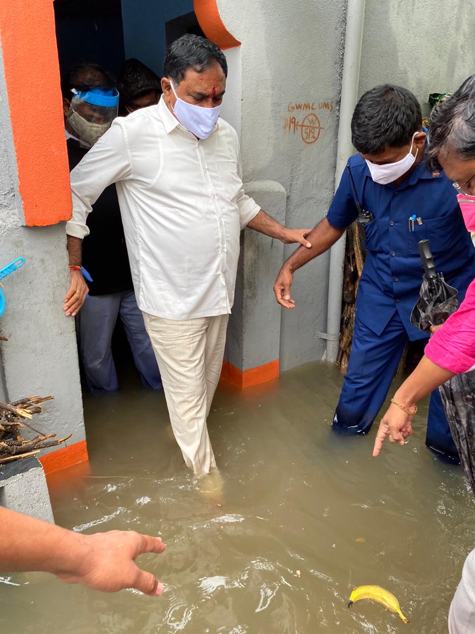 Minister inspecting submerged colonies in warangal district