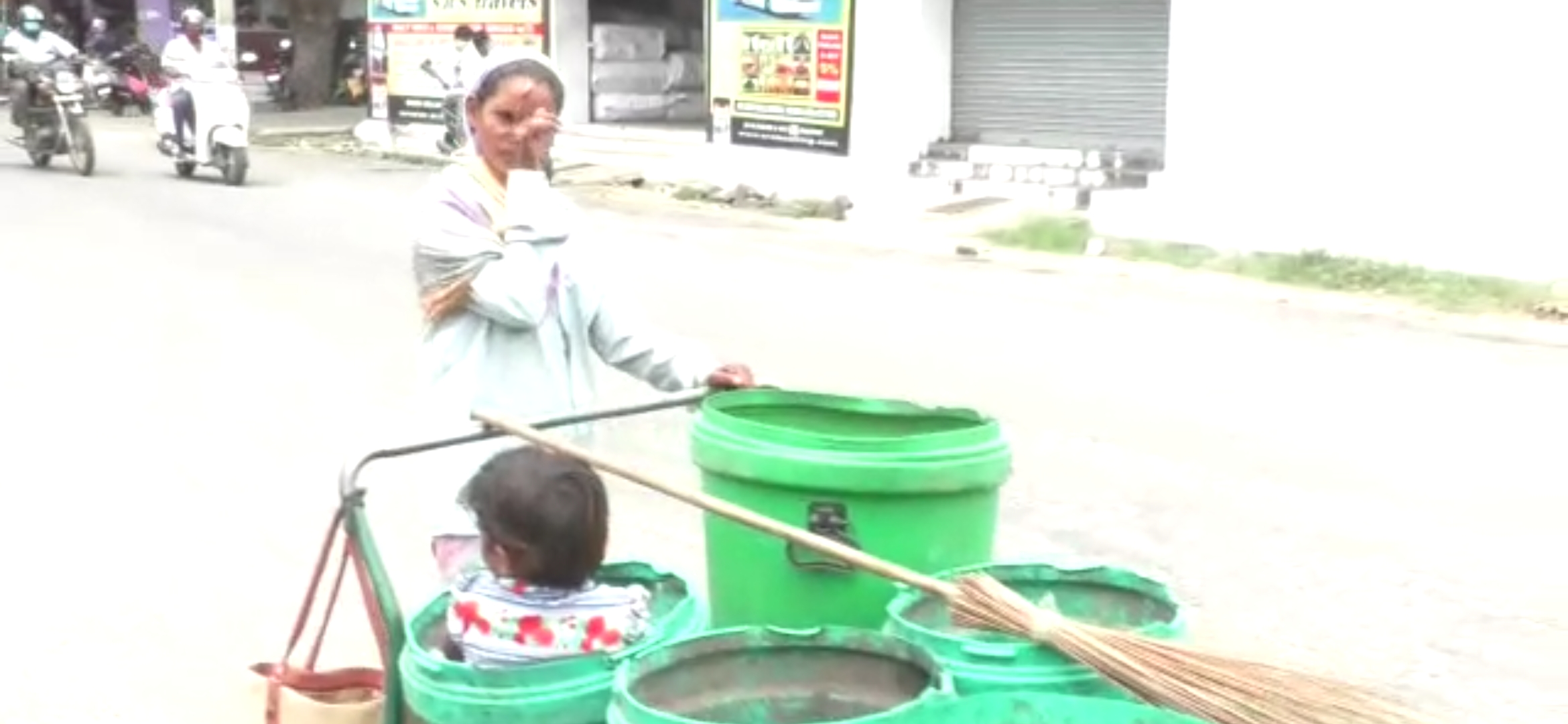 sweeper carries her in dustbin