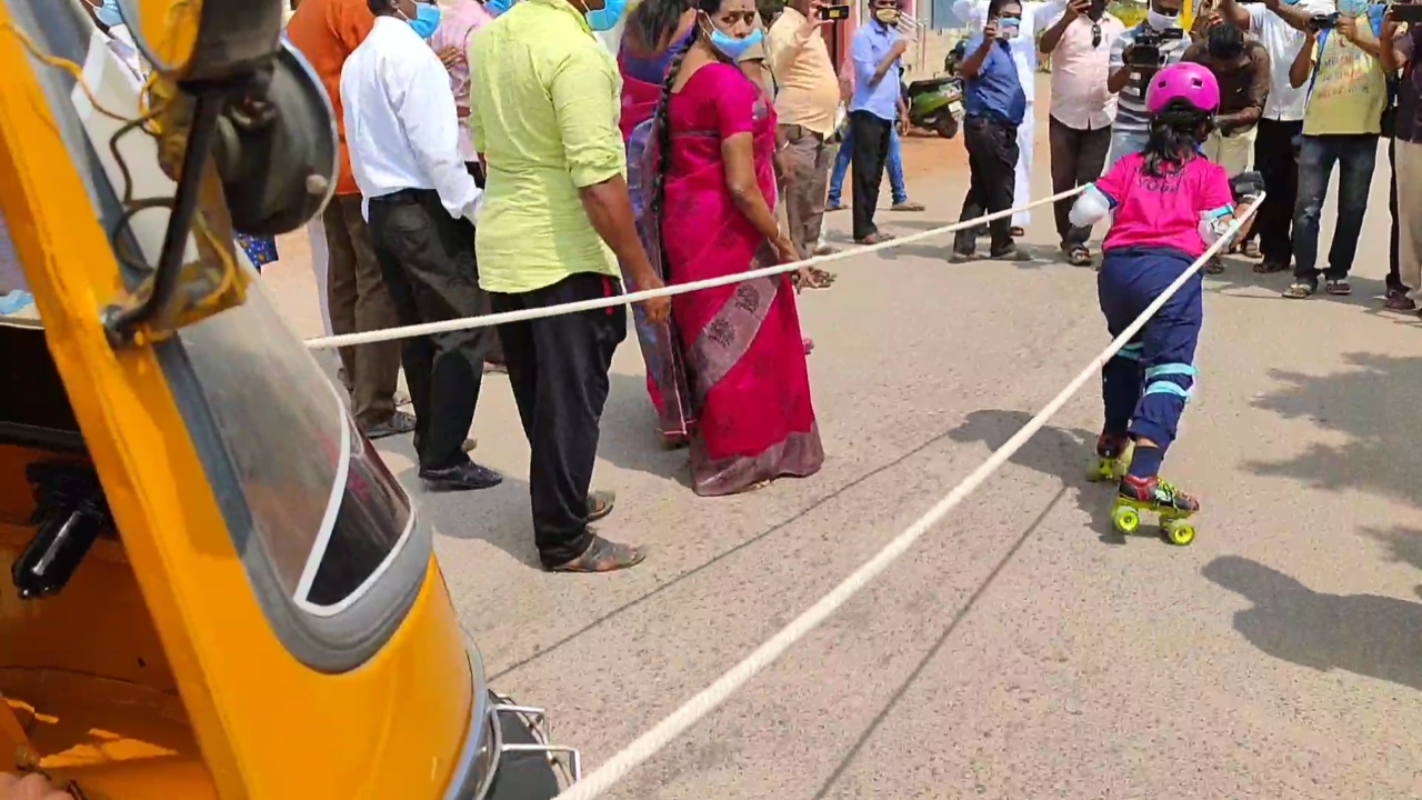 Six year old girl pulls auto by wearing skate roller urging 100 percent voting