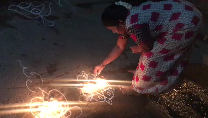 thiruvannamalai district women lighting the lamp in fornt of their house for  Rumors