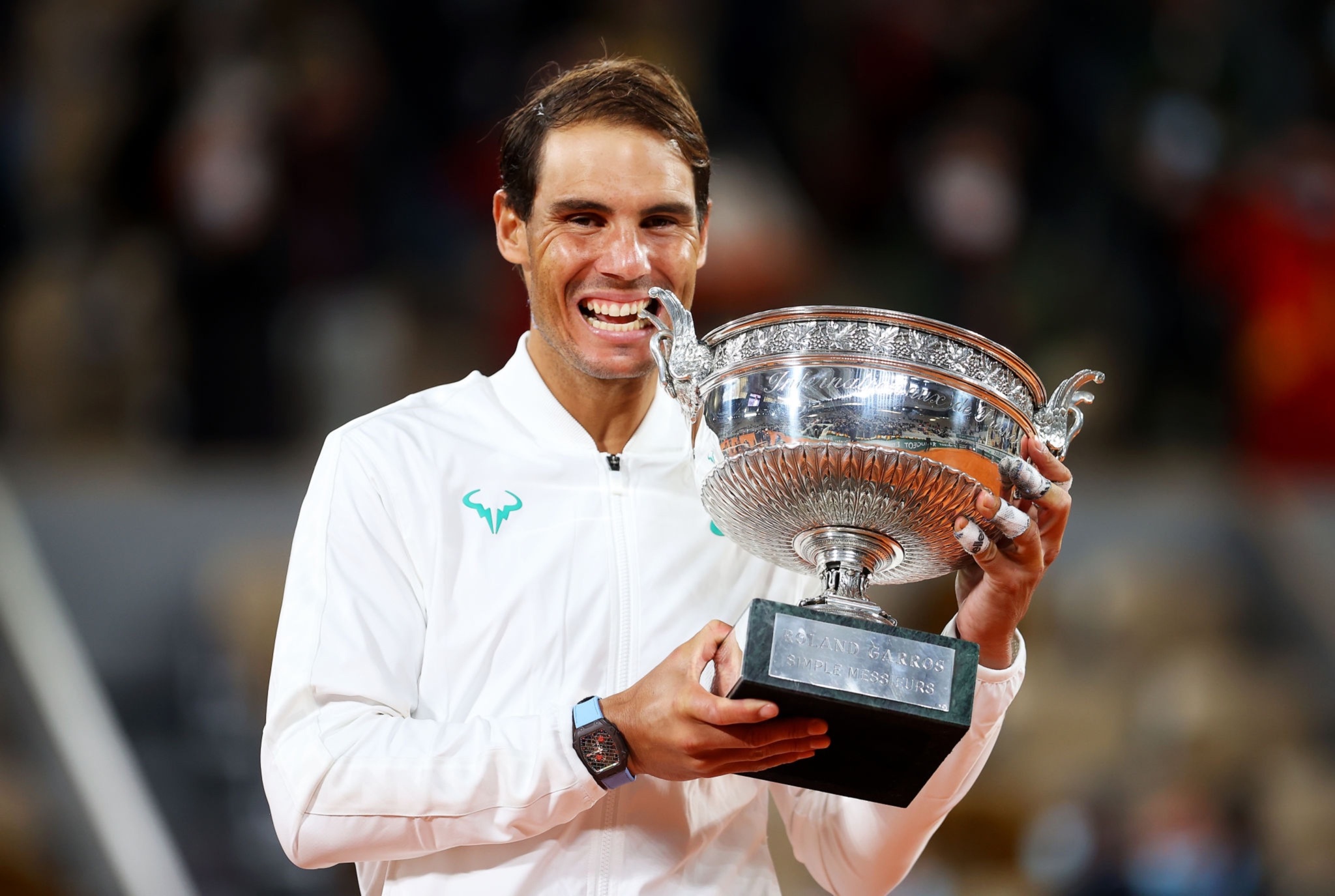 Rafael Nadal's trademark trophy biting celebration.