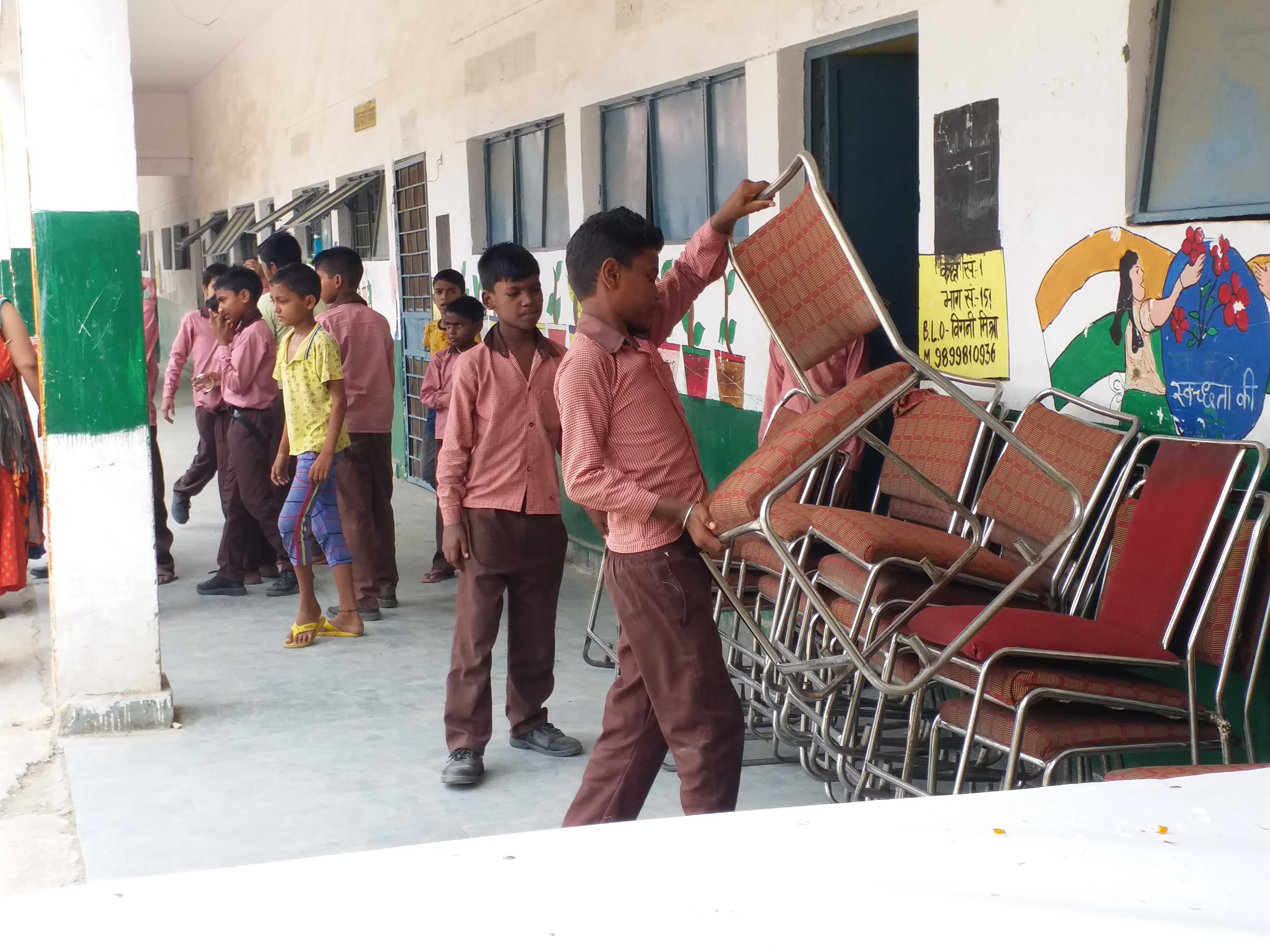 school chidren arrange chair