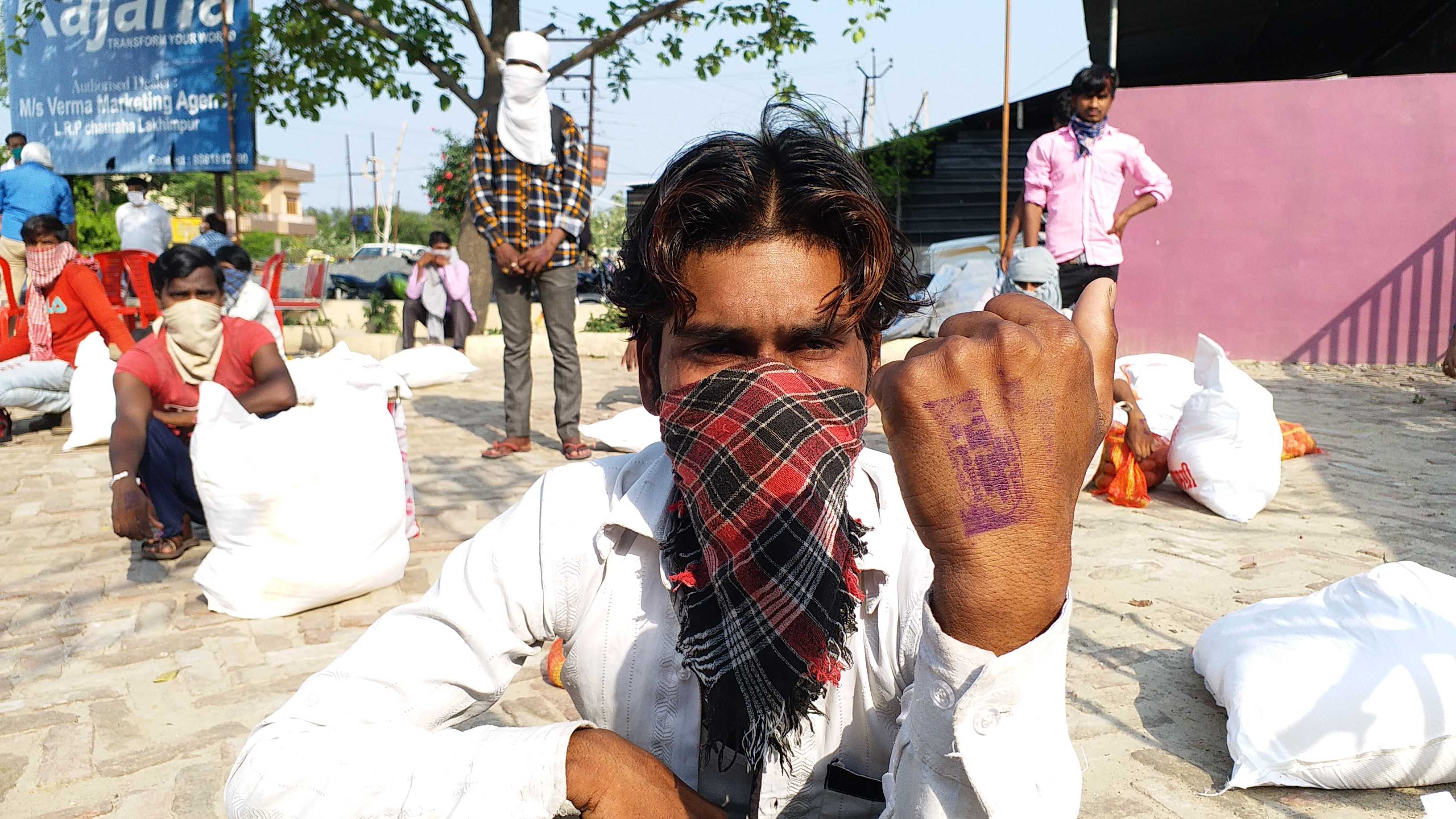 stamp are being put on hands of migrant laborers