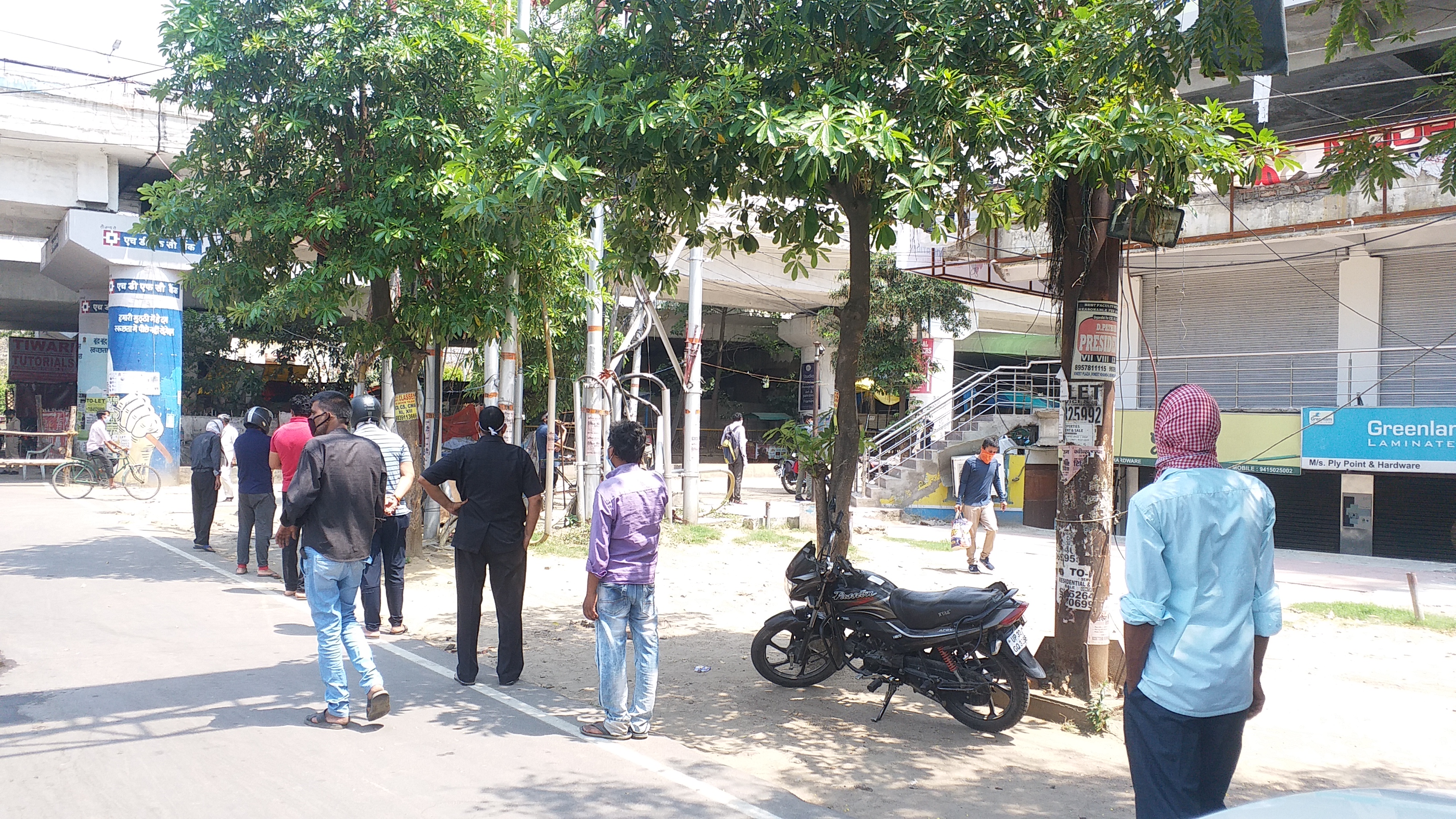 long queue of people outside liquor shops in lucknow