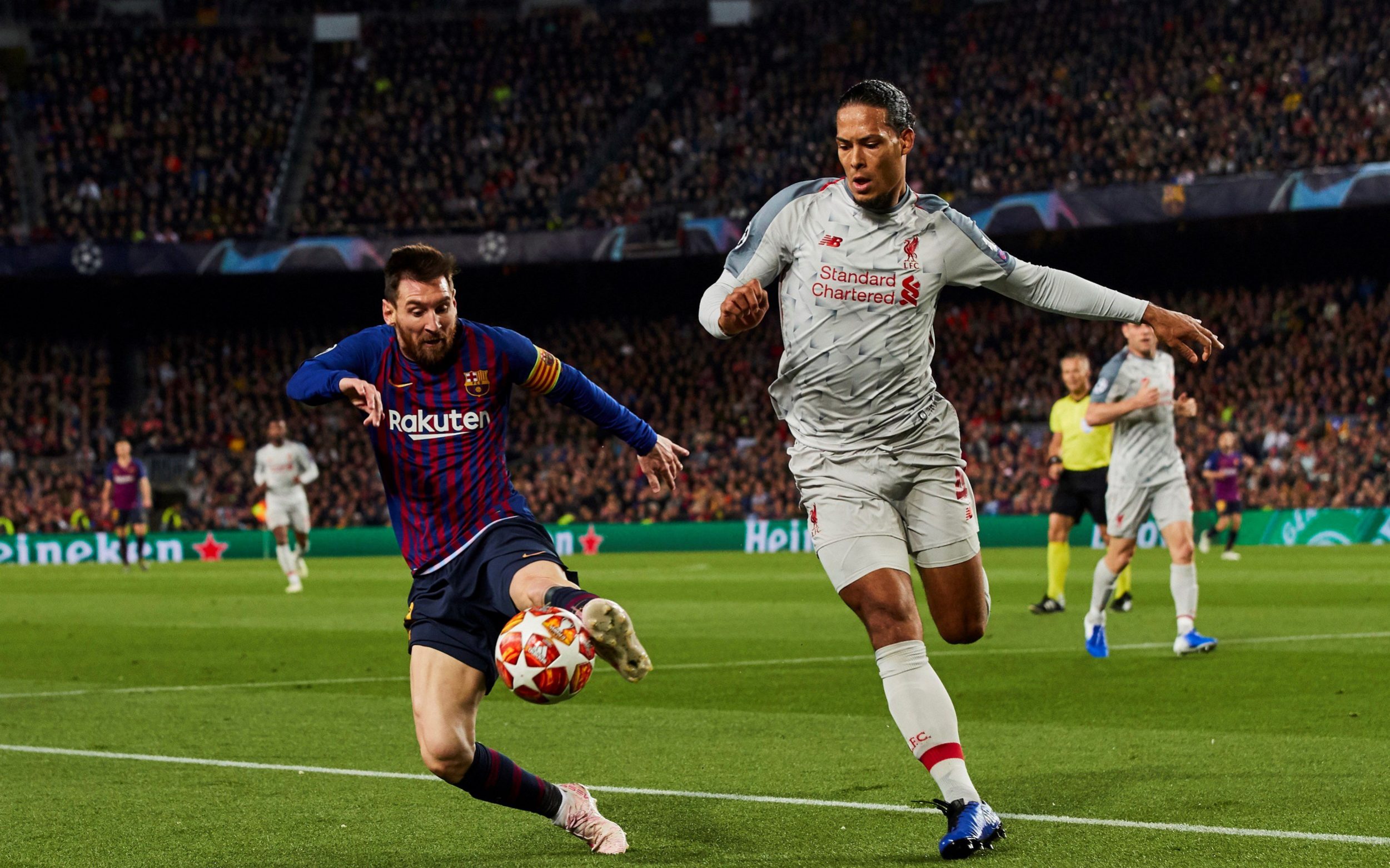 Lionel Messi and Virgil van Dijk in action in a Champions League match.