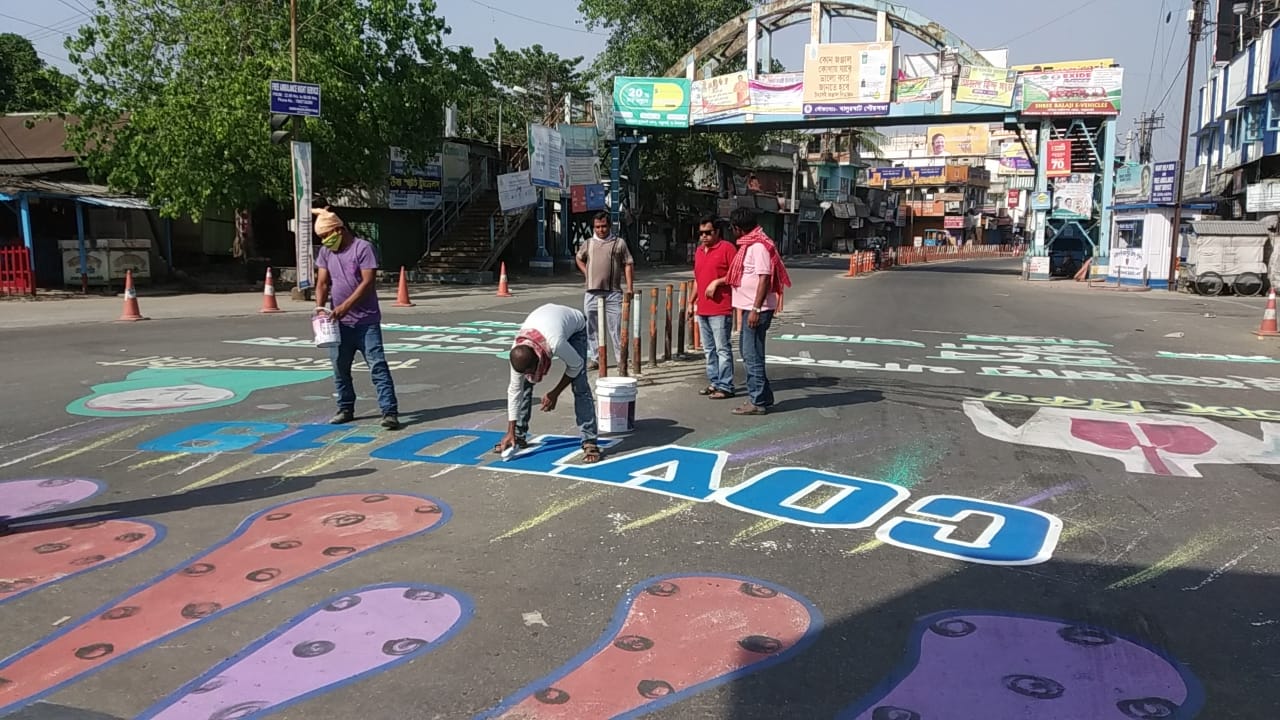 corona awareness words are painted on roads in balurghat , south dinajpur