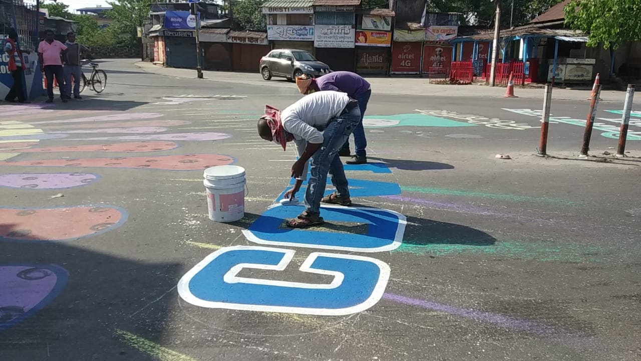 corona awareness words are painted on roads in balurghat , south dinajpur