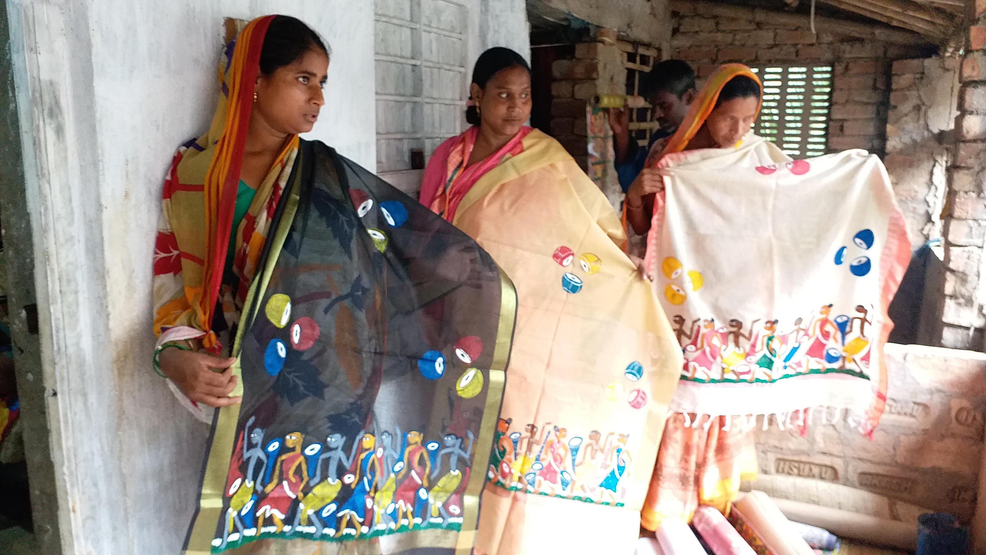 Artists displaying their paintings on sarees