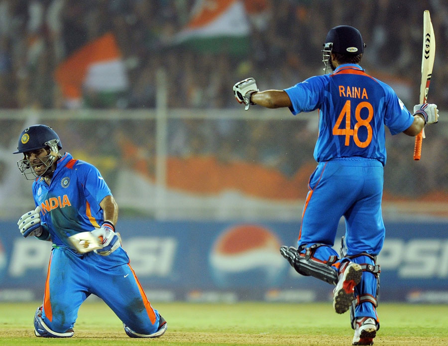 Yuvraj Singh celebrates as Suresh Raina raises his bat after India beat Australia in the 2011 World Cup semi-final.